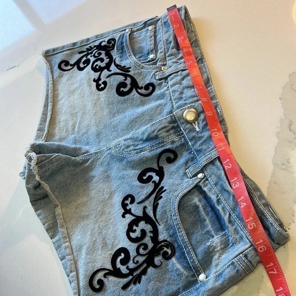 Material Girl light wash jean shorts with black velvet embellishments. Size 7 - Picture 7 of 9